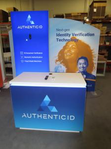 Modified VK-1362 Modular Exhibit with Tension Fabric Graphics, Monitor Mount, Backlt Graphic, LED Stem Light, and Custom Rental Counter with RGB Programmable Lights